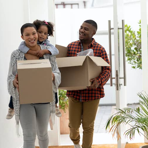 A young family moving in, indicating a new chapter in home ownership or relocation.
