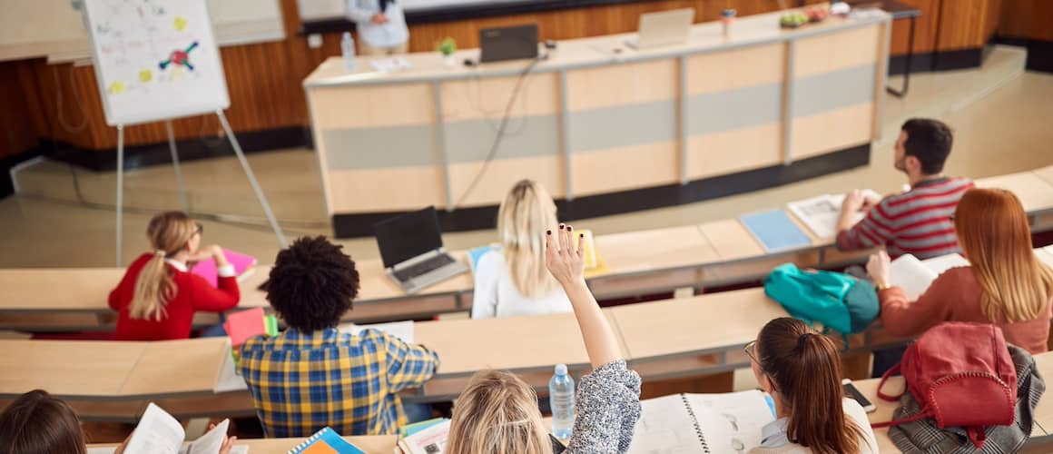 Students sitting in an amphitheater in a college.