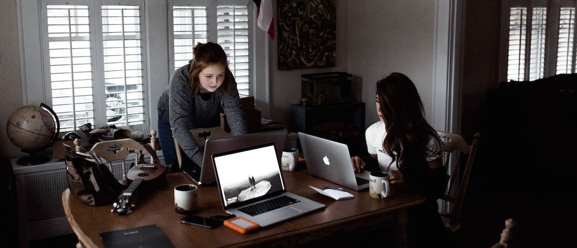 Image of women planning out emergency fund at kitchen table.