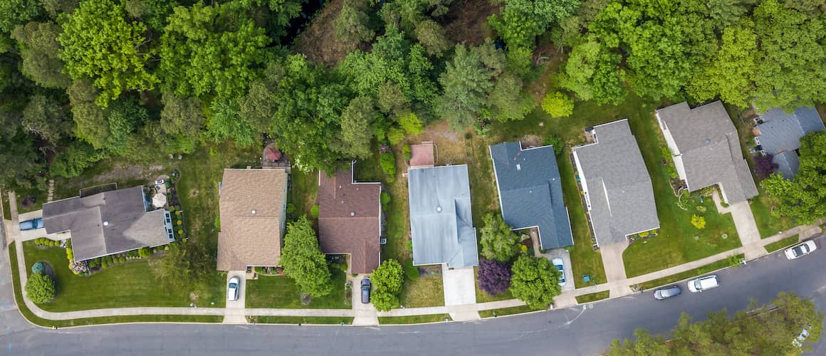 Neatly aligned townhouses or rows of residential buildings in a neighborhood setting.