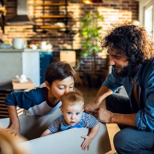 Dad and young sons moving into new home.