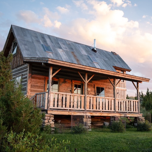 Cabin-style home with a large porch in Wyoming.