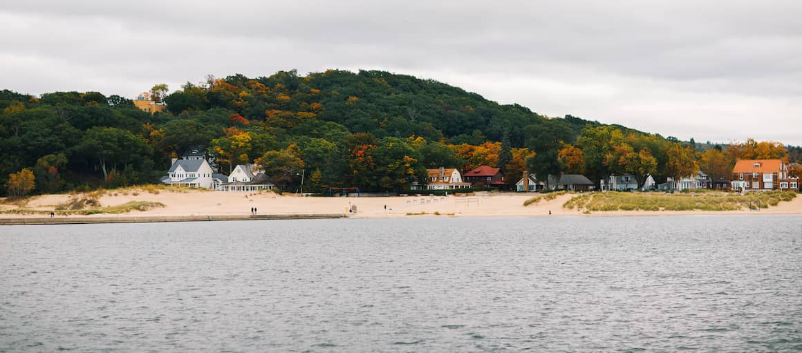 RHB Assets From IGX: A picturesque beach scene in Michigan with calm waters and a clear blue sky.