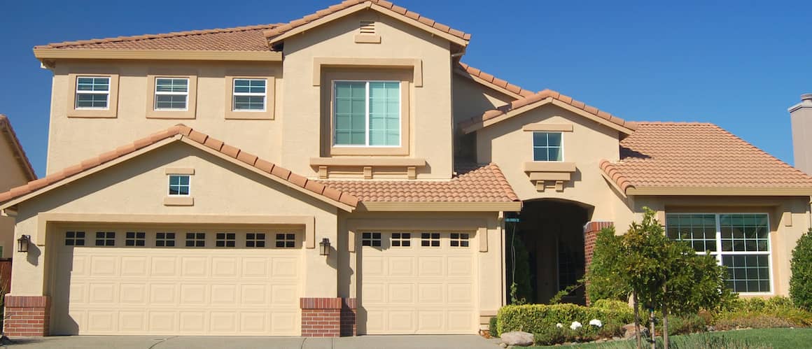 A tan-colored house, possibly representing a residential property with a simple and elegant design.