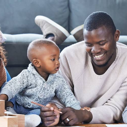 A family playing together in the lounge at home, showing family bonding and leisure time.