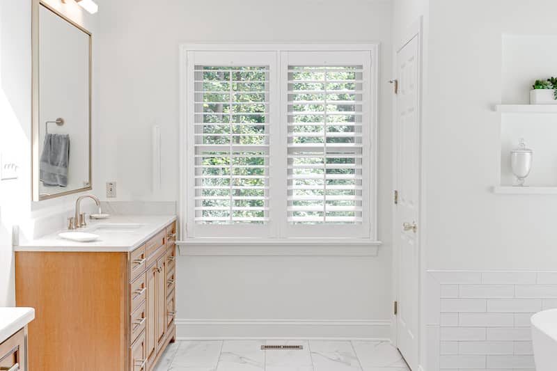 RHB Assets From IGX: White bathroom with plantation shutter window