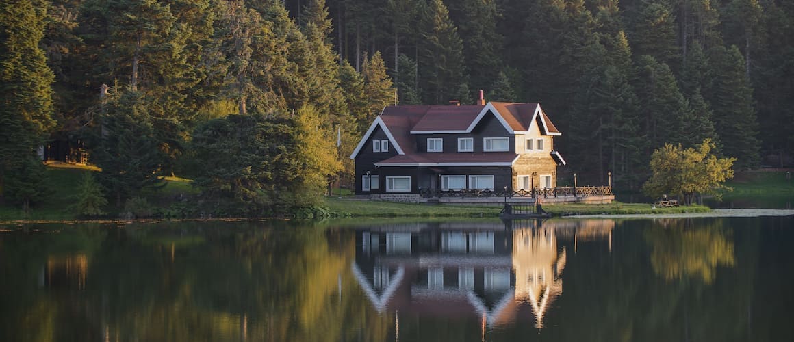 An image depicting a vacant house by a lake, potentially relevant to real estate or property management.