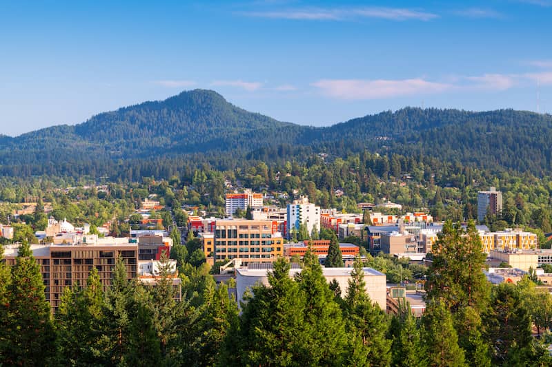 RHB Assets From IGX: Scenic view of Eugene, Oregon, with mountains and lush greenery.