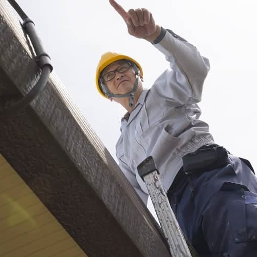 Man inspecting a home, indicating a property inspection process or assessment.