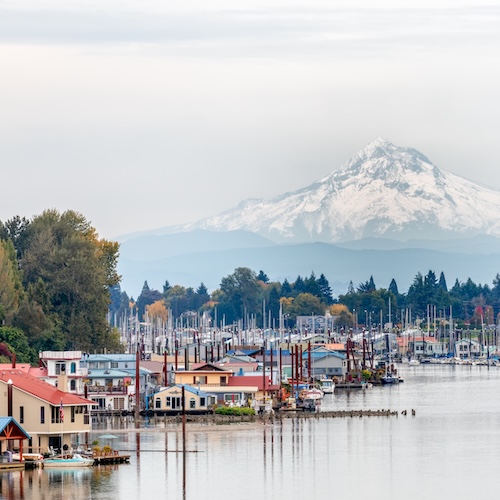 Marina in Portland, Oregon, full of houseboats with Mt. Hood in the background.