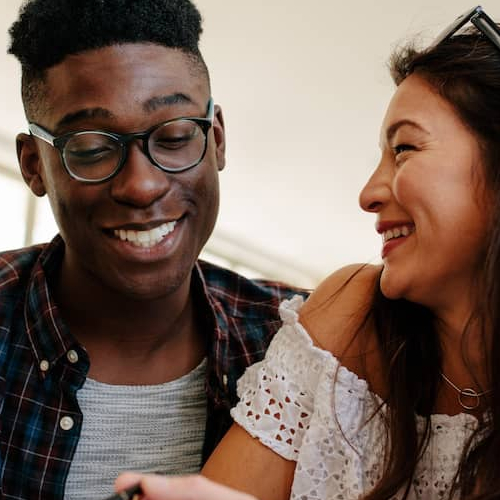 A couple signing papers, potentially associated with finalizing a real estate deal or mortgage agreement.