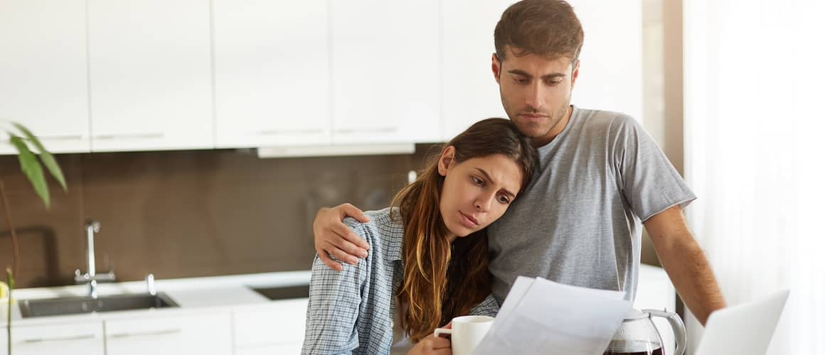 Portrait of unhappy young couple having looking worried 