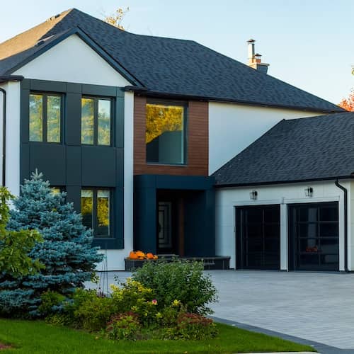 Modern luxury home exterior with two garages.