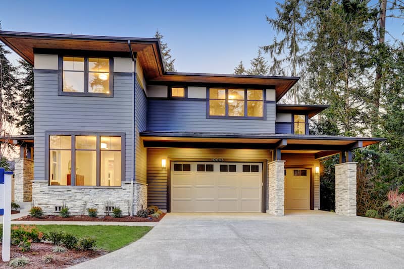 Exterior of a dark blue prairie style modern home.