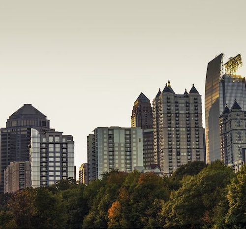 Midtown Atlanta skyline viewed from Piedmont Park, depicting an urban cityscape.