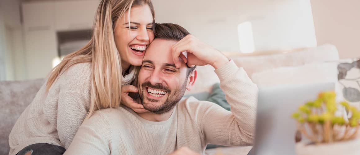 Image of couple enjoying new furniture in home.