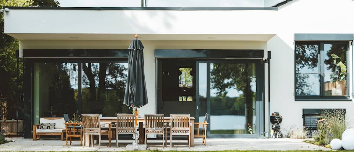 Patio outside home with sliding glass doors outside living room.