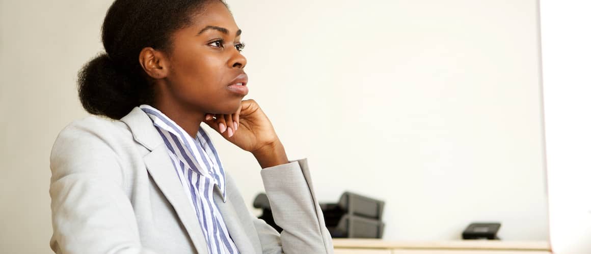 African American business woman reviewing finances in her office.