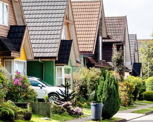 An image of a traditional neighborhood setting, depicting houses in a residential area.