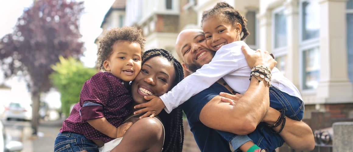 Image depicting a black family of four, possibly emphasizing diversity or representation.