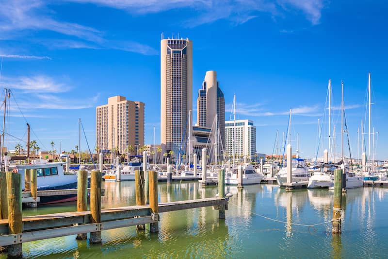 RHB Assets From IGX: Corpus Christi, Texas skyline along the bay with reflection on water.