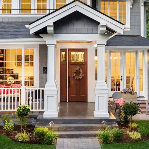 House with a brick path, highlighting architectural details and landscaping in a residential setting.