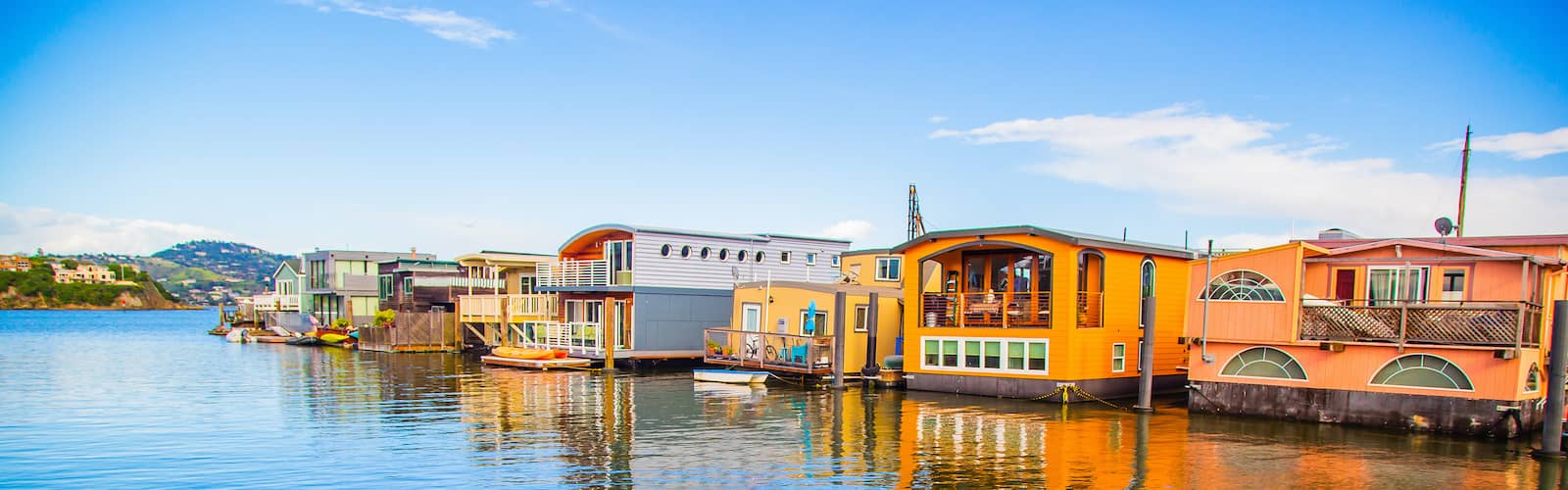 Houseboats floating on water, likely in a residential area.