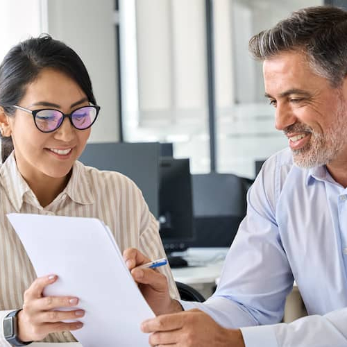 An account advisor showing papers to a client, indicating a professional interaction or financial consultation.