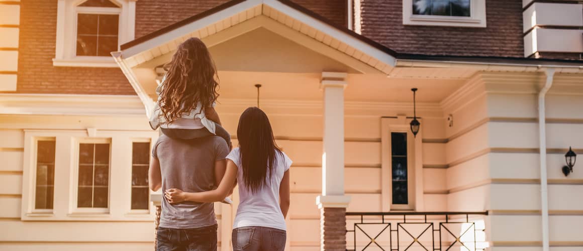 A family looking at a house possibly their own resident.