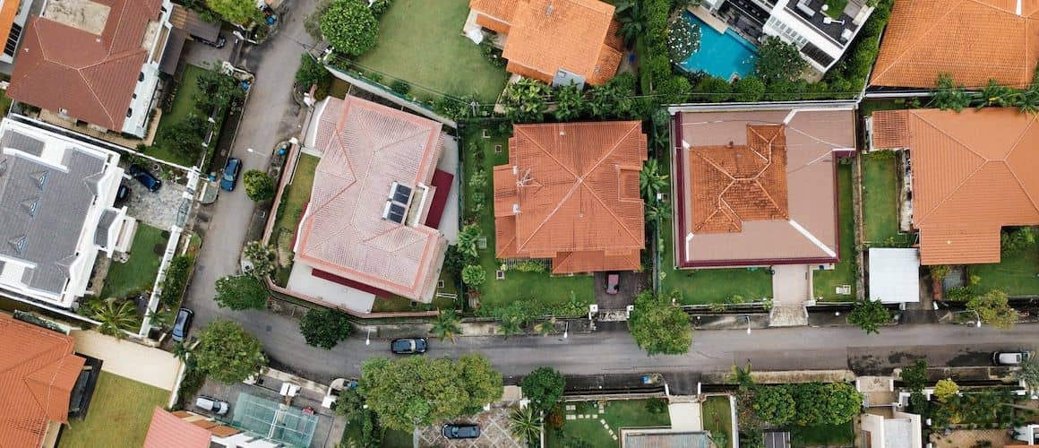 Aerial shot of a neighborhood, showcasing houses, streets, and community living.