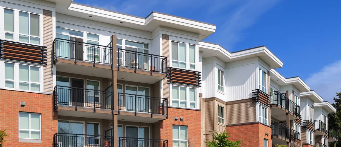 An orange and white apartment building, representing urban or multi-unit living spaces.