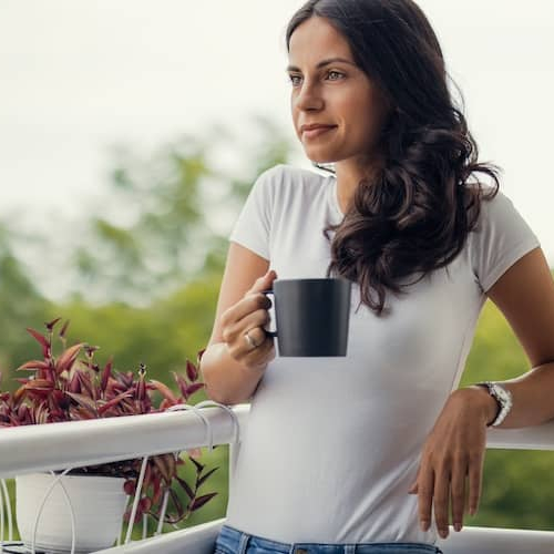 Woman Standing On Her Balcony