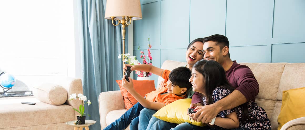 A family enjoying moments in their lounge and playing video game.