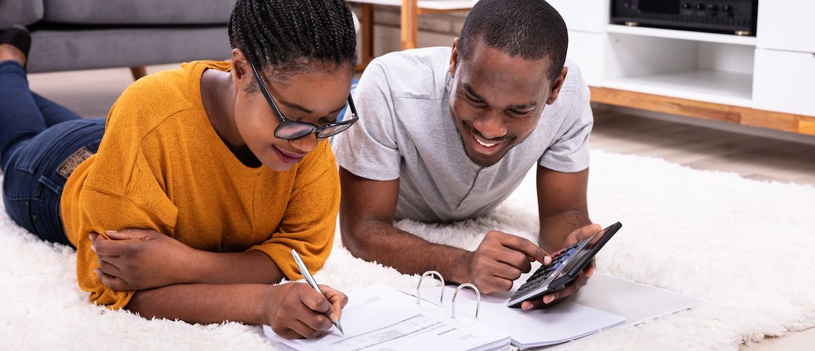 Stock-Young-Couple-Doing-Finances-In-Living-Room-Adobe-Stock-242978776-copy.jpg