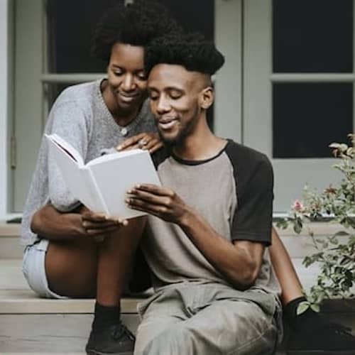A couple reading, potentially exploring information related to homeownership or mortgages.