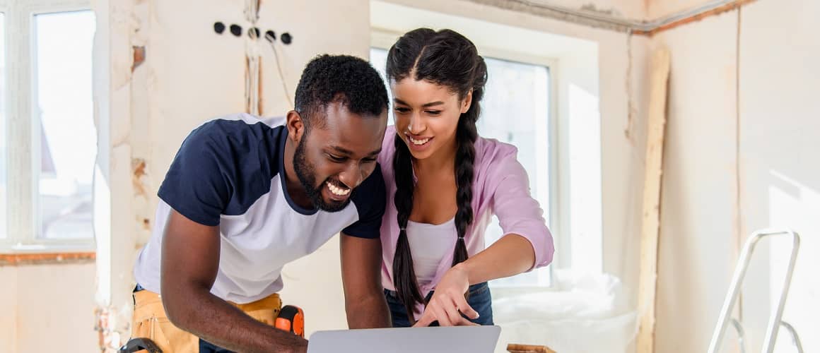 An African American couple engaged in home renovation or remodeling.