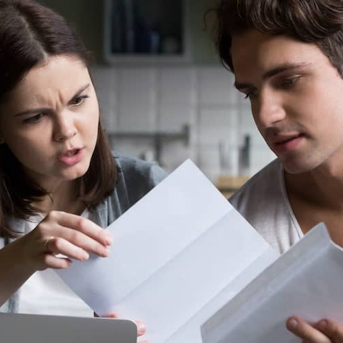 A frustrated young couple, expressing frustration or stress.