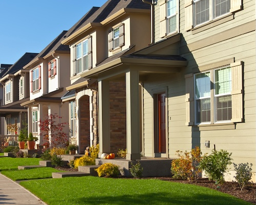 Row of houses on sunny street.