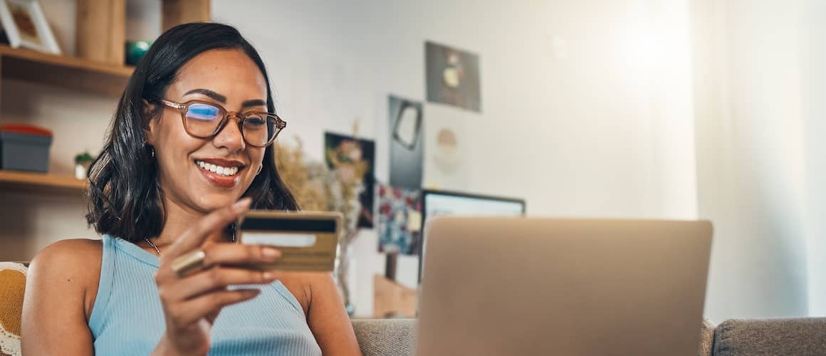 Woman On Couch With Laptop Credit Card