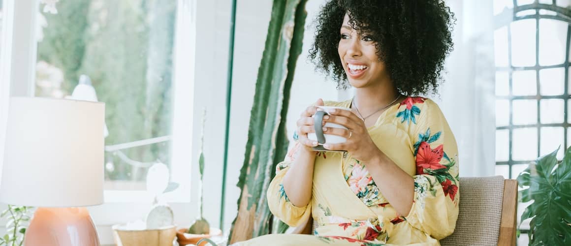 A lady drinking coffee at home, representing relaxation or daily routines at home.