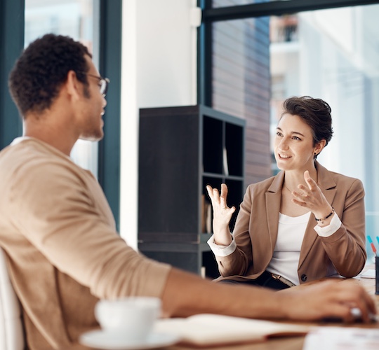 Man talking to a businesswoman in an office.