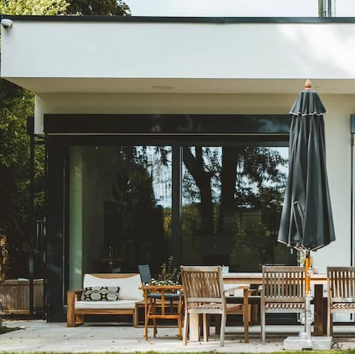 Patio outside home with sliding glass doors outside living room.