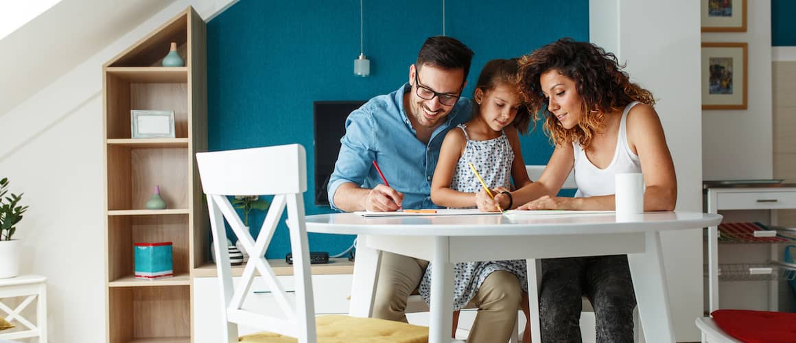 Image of a mother and father drawing with their child, suggesting a family-oriented activity.