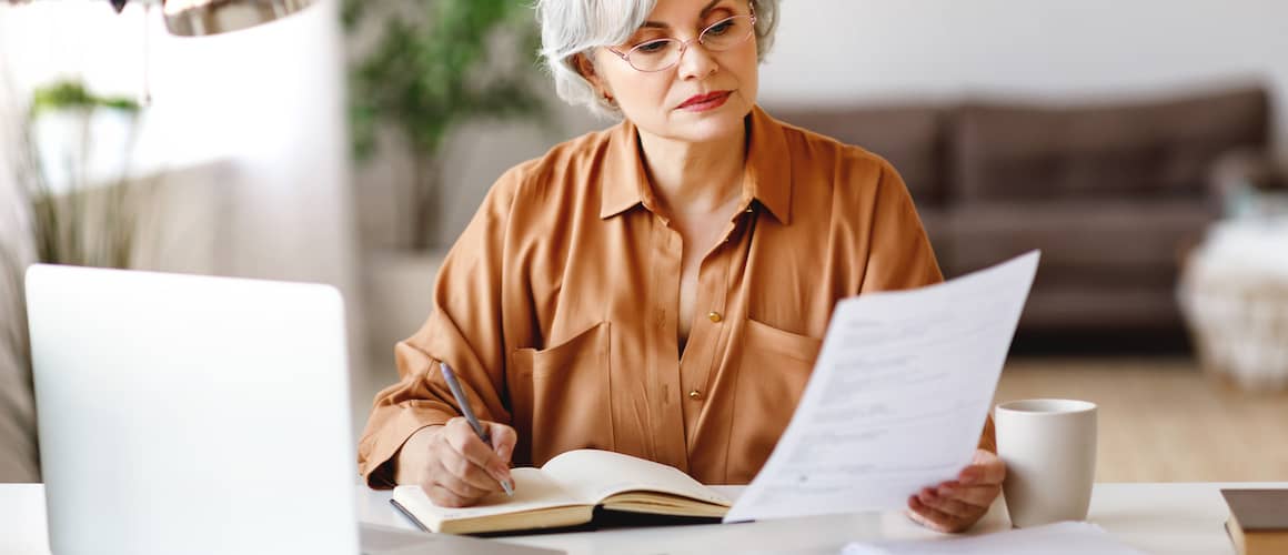 Image of woman reviewing her monthly bills.