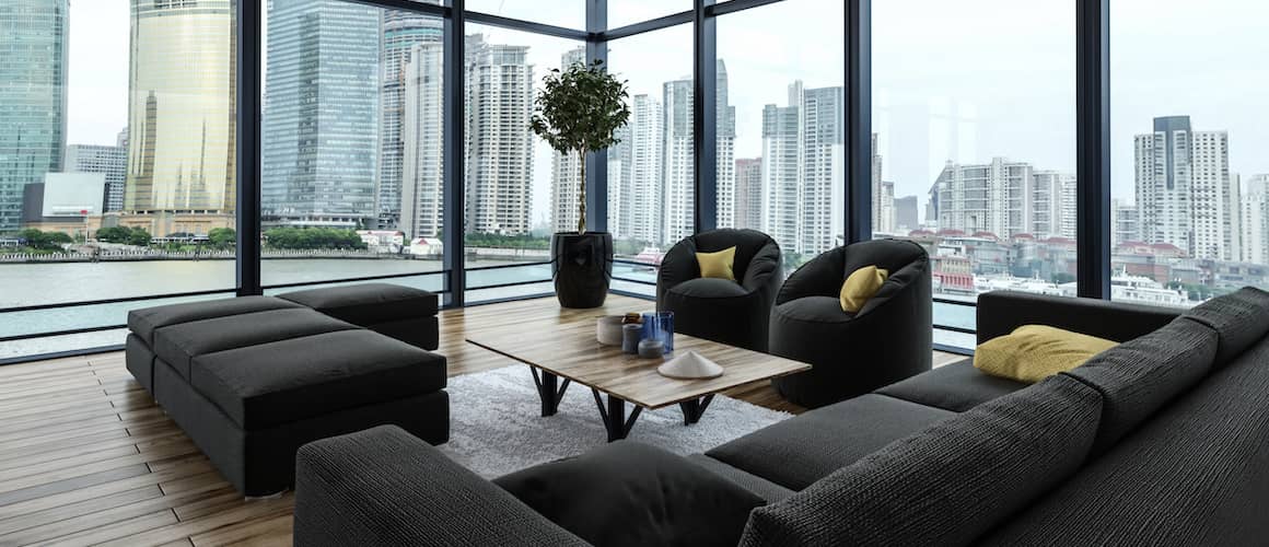 A modern neutral-colored living room with large windows and stylish furniture.