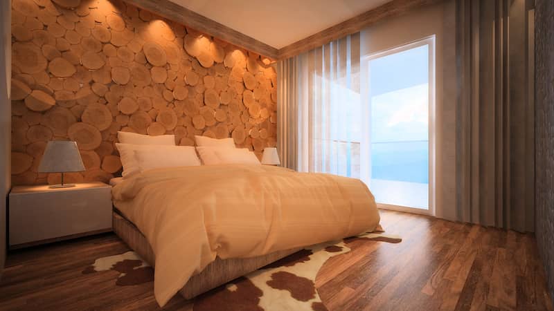 RHB Assets From IGX: A serene primary bedroom featuring a wood cut accent wall.