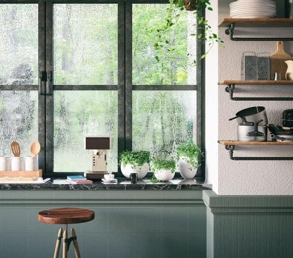 A loft kitchen with a window wall and cooking utensils.