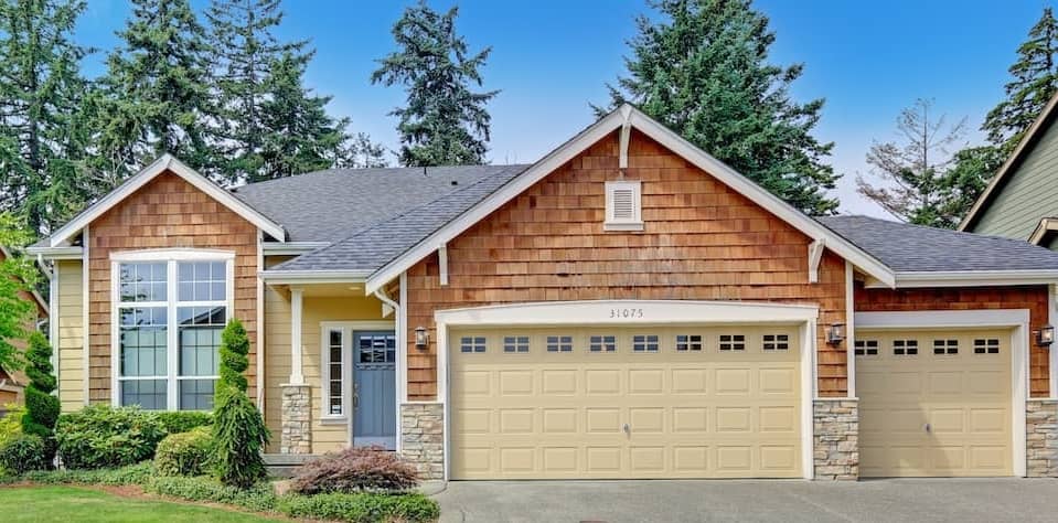 Exterior of a house with wood siding, displaying architectural details and materials.