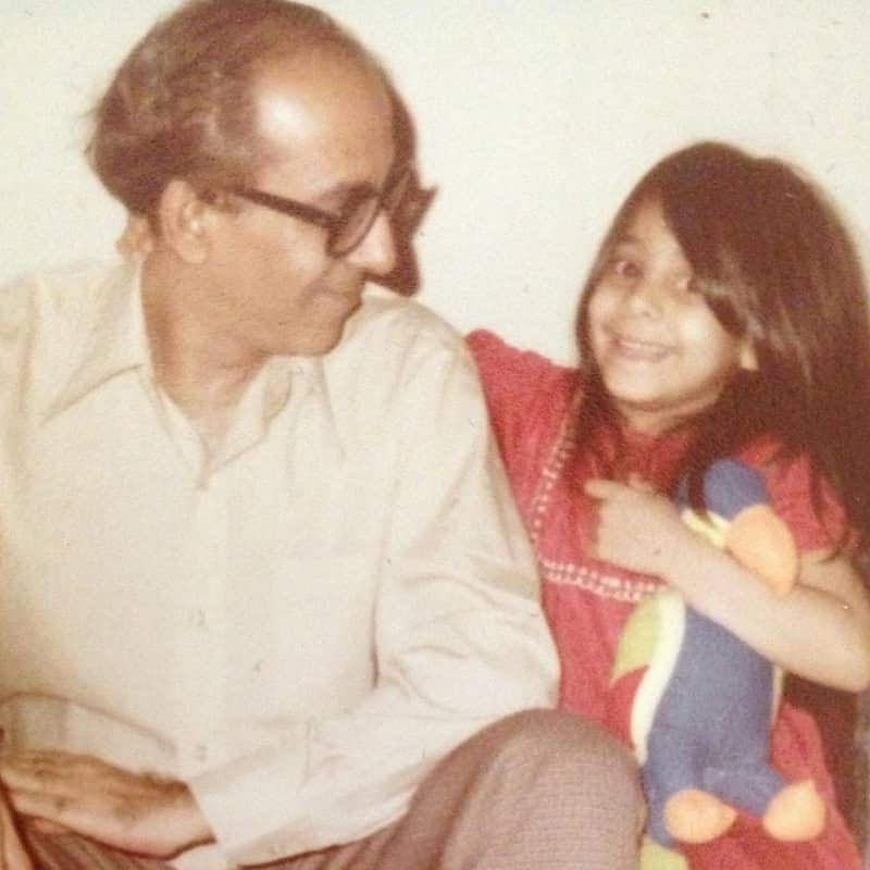 Father and daughter smiling together.