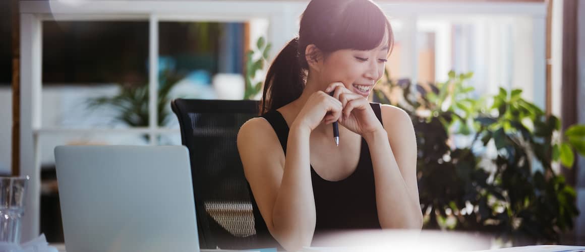 A woman looking at a deed, potentially involved in property ownership or real estate matters.